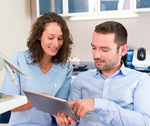 Dentist going over teeth whitening treatment with patient