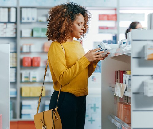 A patient looking at drugstore teeth whitening options