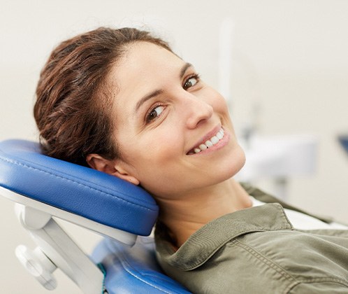 Woman in dental chair smiling 