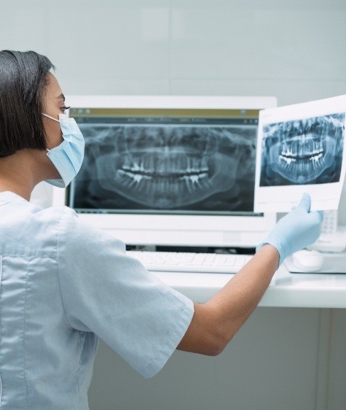 Dental team member reviewing digital dental x-rays
