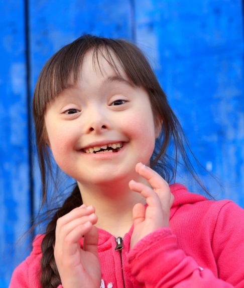 Young child smiling after special needs dentistry visit