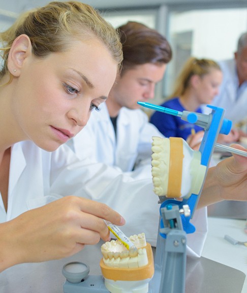 Lab workers making dentures