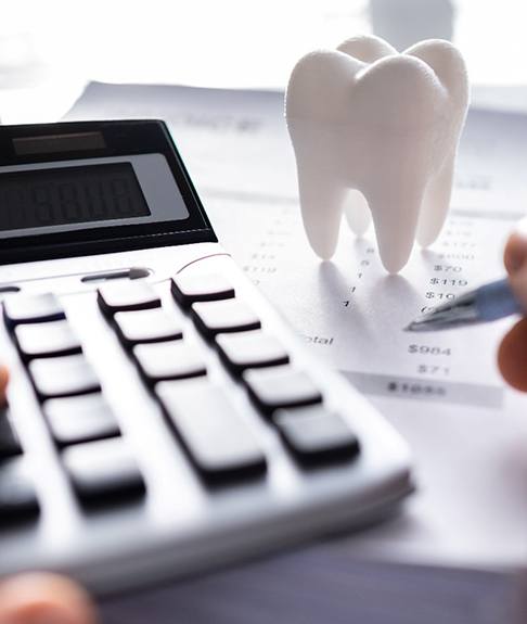 A patient calculating the cost of emergency dentistry
