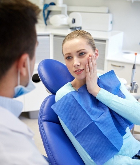 Woman visiting dentist to discuss keys to preventing dental emergencies