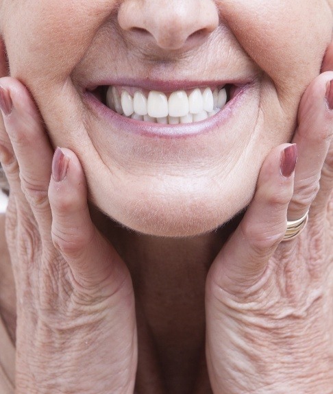 Closeup of patient smiling and enjoying the benefits of dental implants