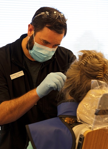 Dental team member treating dental patient in Lakewood