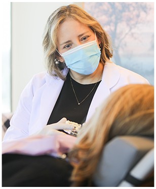 Dentist in Lakewood talking to dental patient