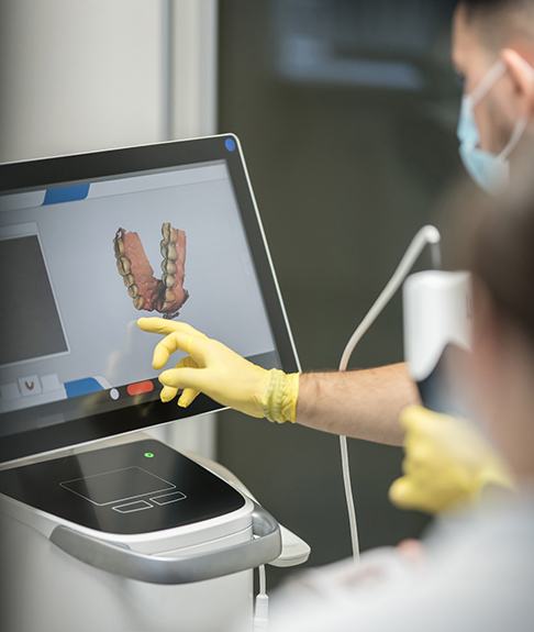 Dentist and patient reviewing digital scan of teeth