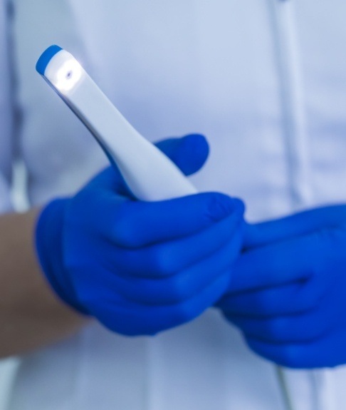 Dentist holding an intraoral camera