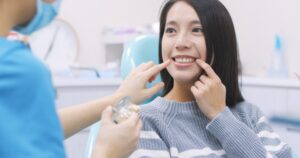 Woman asking her dentist about veneers and teeth whitening